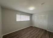 Thumbnail 7 of 15 - an empty living room with a window and a closet