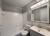 Thumbnail 4 of 15 - a bathroom with a sink toilet and a bath tub