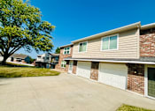 Thumbnail 28 of 32 - A residential building with a tree in front of it.