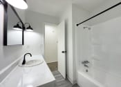 Thumbnail 6 of 26 - a bathroom with a sink and a tub and a shower