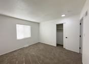 Thumbnail 9 of 26 - an empty living room with carpet and a door to a closet