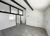 Thumbnail 4 of 26 - the living room of a new home with white walls and wood flooring
