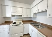 Thumbnail 4 of 12 - a kitchen with white cabinets and white appliances