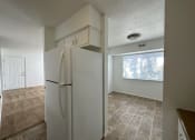 Thumbnail 5 of 12 - a kitchen with a refrigerator and a window