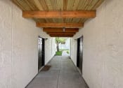 Thumbnail 9 of 12 - a hallway with doors and a wooden ceiling