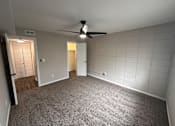 Thumbnail 9 of 17 - A room with a ceiling fan and tile walls.