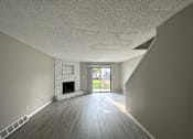 Thumbnail 1 of 8 - an empty living room with a fireplace
