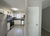 Thumbnail 3 of 8 - a kitchen with white cabinets and stainless steel appliances
