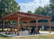 Thumbnail 4 of 39 - a wooden pergola with a table and chairs under it