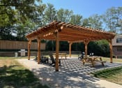 Thumbnail 5 of 39 - a wooden pergola with a stone patio