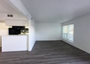 Thumbnail 1 of 19 - A spacious room with a white cabinet and a television.