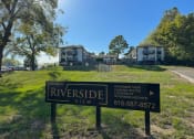 Thumbnail 4 of 6 - a view of riverside view apartments from the street with a sign