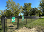 Thumbnail 6 of 6 - a chain link fence with green signs on it