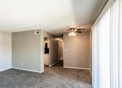Thumbnail 13 of 23 - Spacious living room looking into kitchen and down the hallway