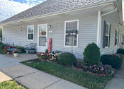 Thumbnail 16 of 17 - A house with a grey siding and a red mailbox.