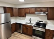 Thumbnail 21 of 39 - a kitchen with stainless steel appliances and wooden cabinets