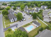 Thumbnail 24 of 25 - an aerial view of a neighborhood with houses and a swimming pool