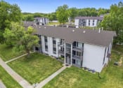Thumbnail 19 of 25 - an aerial view of a building with green grass and trees