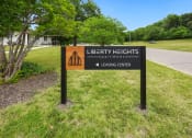Thumbnail 23 of 25 - a sign for liberty heights park in front of a road