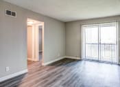 Thumbnail 6 of 16 - an empty living room with wood floors and a large window