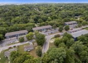Thumbnail 14 of 14 - an aerial view of several buildings surrounded by trees and a parking lot