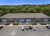 Thumbnail 13 of 14 - an aerial view of an apartment building with a parking lot