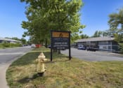 Thumbnail 10 of 14 - a sign and a yellow fire hydrant in front of a parking lot