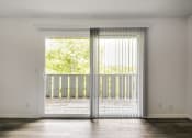 Thumbnail 4 of 14 - an empty living room with sliding glass doors and a balcony