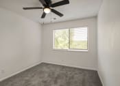 Thumbnail 6 of 14 - an empty room with a ceiling fan and a window