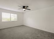 Thumbnail 7 of 14 - an empty room with a ceiling fan and a window