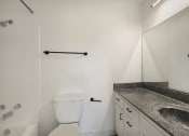 Thumbnail 9 of 14 - a bathroom with a sink and a toilet