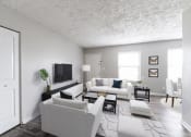 Thumbnail 2 of 15 - a living room with white furniture and a tv
