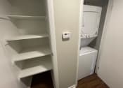 Thumbnail 2 of 7 - a small closet with a washer and dryer in it
