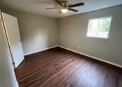 Thumbnail 3 of 7 - an empty room with wooden floors and a ceiling fan