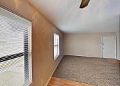 Thumbnail 12 of 15 - an empty living room with a large window and a door