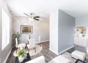 Thumbnail 13 of 15 - a living room and dining room with white furniture and a ceiling fan