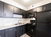 Thumbnail 14 of 15 - a kitchen with black appliances and black cabinets