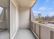 Thumbnail 4 of 15 - A balcony with a glass door and a view of the outside.