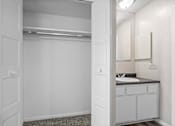 Thumbnail 7 of 15 - A white bathroom with a sink and mirror.