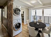 Thumbnail 21 of 25 - A modern laundry room with a washer and dryer built into a cabinet.
