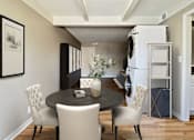 Thumbnail 18 of 25 - A dining room with a table and chairs.