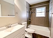 Thumbnail 24 of 25 - A white sink and toilet in a bathroom.