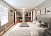 Thumbnail 5 of 25 - A bedroom with a large bed and a walk-in closet.