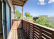 Thumbnail 2 of 25 - A wooden deck with a view of the sky and buildings.
