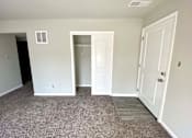 Thumbnail 5 of 28 - A room with a white door and a window.