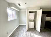 Thumbnail 11 of 28 - A kitchen area with a refrigerator and a cabinet.