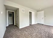 Thumbnail 3 of 28 - A room with carpeted floor and white walls.