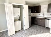 Thumbnail 14 of 28 - A kitchen with a white dishwasher and a white refrigerator.