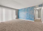 Thumbnail 2 of 10 - A room with a blue wall and carpet.
