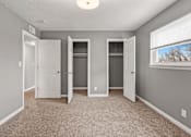 Thumbnail 5 of 10 - A room with three doors and a window.